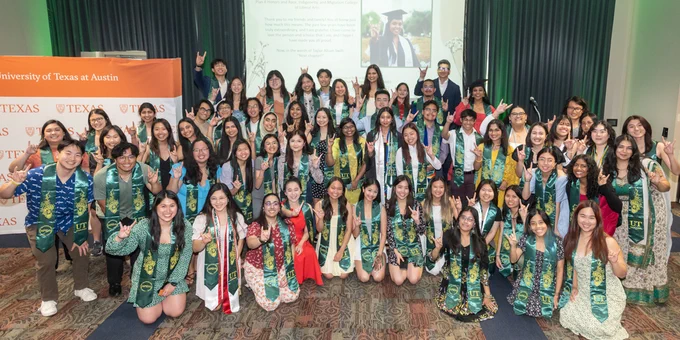 large group shot featuring dozens of AAPI graduates at UT Austin. 