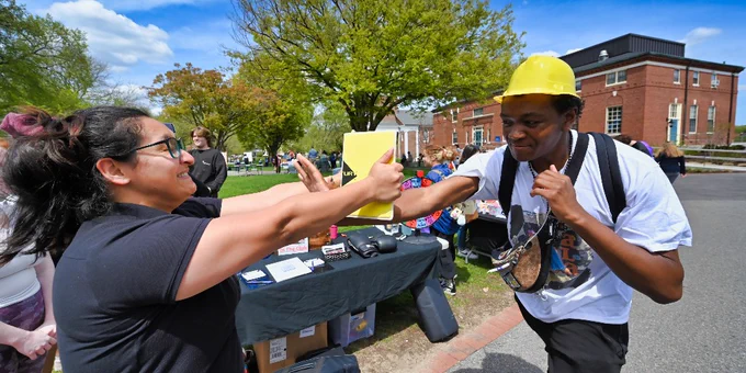 A student demonstrates a self defense tactic with a professional during the Spring into Wellness resource fair.