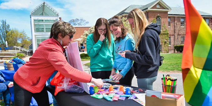 Three students peruse a table during the Spring Into Wellness resource fair.
