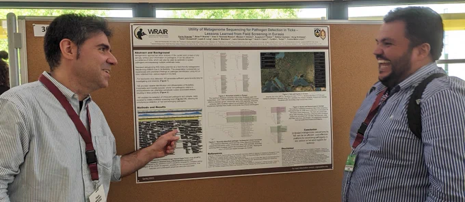 Koray Ergunay discusses his findings in front of a poster with Jader Oliveira