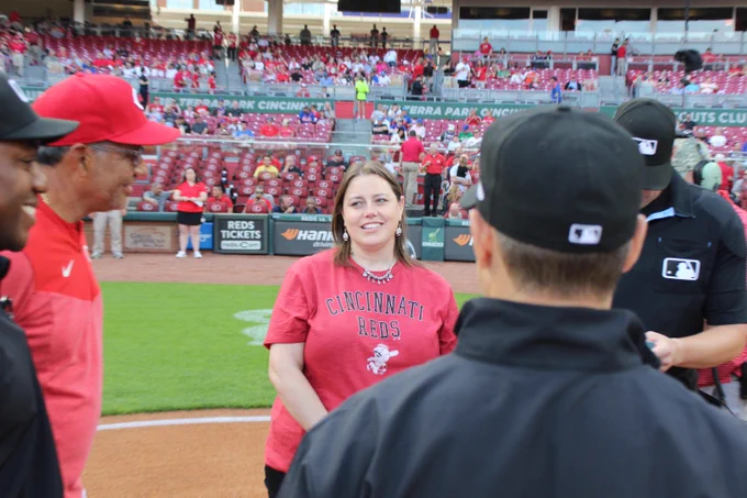 Stephanie Herber meets with coaches from both team and the umpiring crew of the 5/10/23 match-up between the Cincinnati Reds and the New York Mets. Stephanie served as Honorary Captain prior to the game.