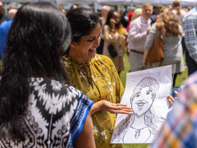 A woman showing another woman a picture of herself