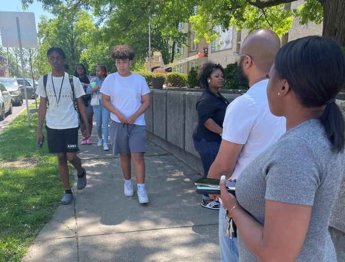 Students walk on a sidewalk.
