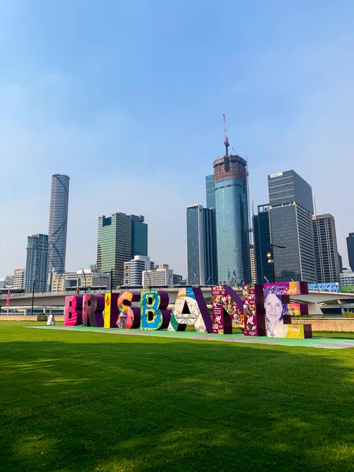 Photo of brisbane skyline with large word 'Brisbane' spelled out in front.  Photo by Mrt Ziolko: https://www.pexels.com/photo/the-artful-sign-of-brisbane-in-the-park-10731556/