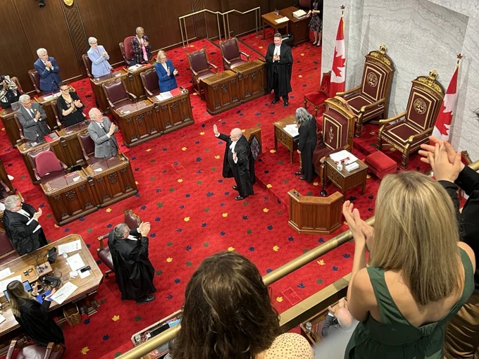 View from above the floor with Senate Furey receiving a standing ovation. 