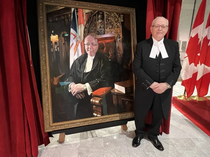 Senator with his portrait. 