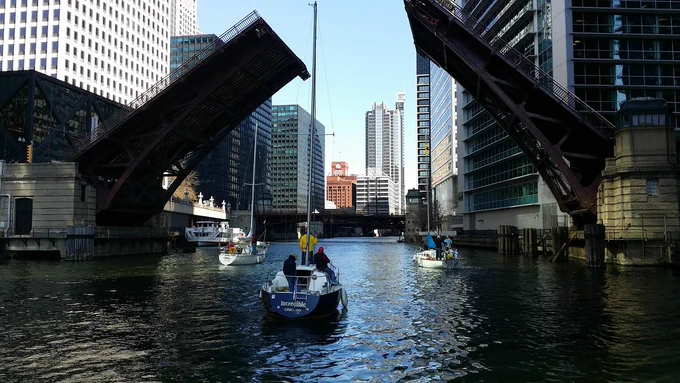 Sailboat approaching open drawbridge in Chicago, USA.