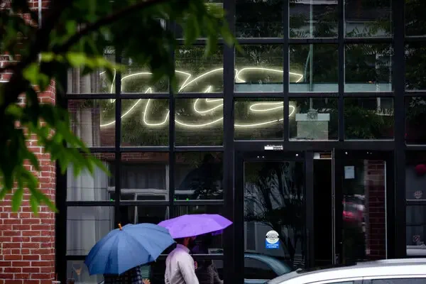 People with umbrellas enter the Vice Media offices in Brooklyn in June 2019. Credit: Stephen Speranza for The New York Times