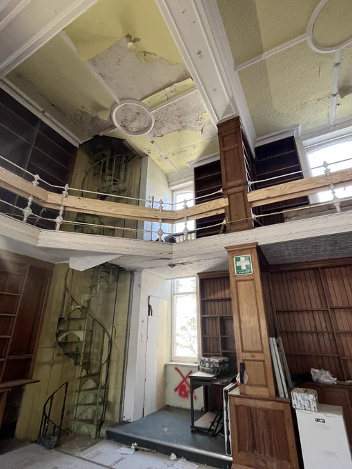 Panelled library with spiral staircase