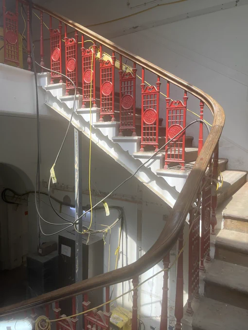 A staircase with red ironwork