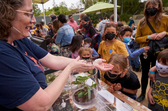 Live Animal Care Team Manager Leslie Gordon shares a closer-look of a live insect with Bug Fair patrons.