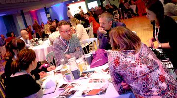 Four women and two men sitting at a round table at a CIPR event.