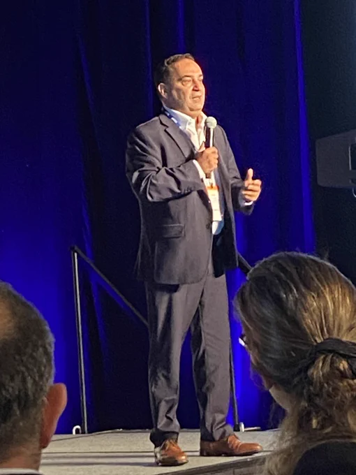 Photo of Bar Veinstein on stage at ELUNA 2023.