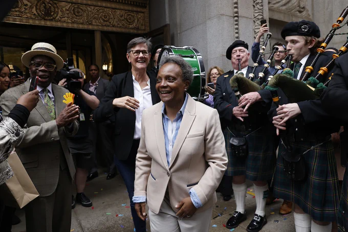 Photo ID: The Mayor and First Lady exit City Hall. 