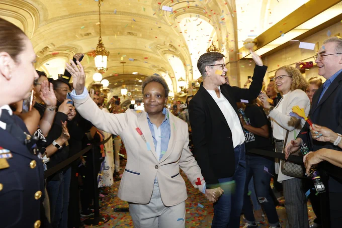 Photo ID: The Mayor and First Lady walk out of City Hall. 