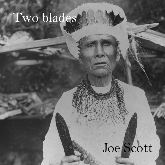 Image of an older man with a headdress holding two blades with the text “Two blades Joe Scott”
