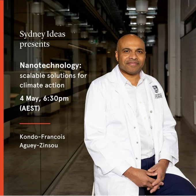 Francois Aguey-Zinsou sits on a stool in a low-lit laboratory corridor. He's wearing a white University of Sydney lab coat.