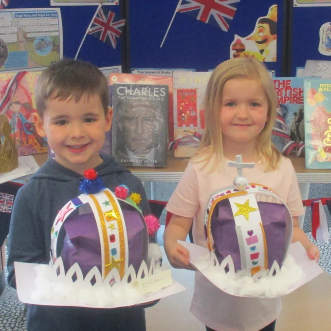 children holding crowns made from craft materials