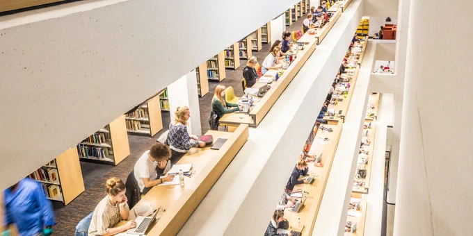 A shot from above of students studying at the Edward Boyle Library.