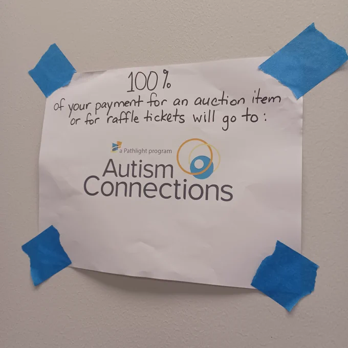 Sign that says 100% of your payment for an auction item or for raffle tickets will go to Autism Connections, a Pathlight program