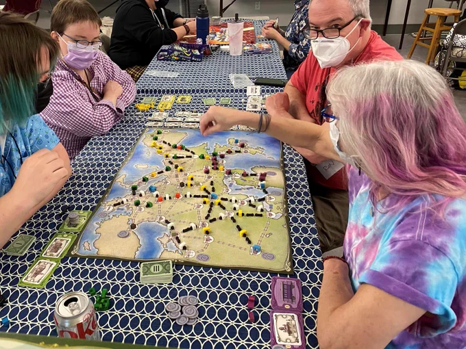 4 people playing a different board game