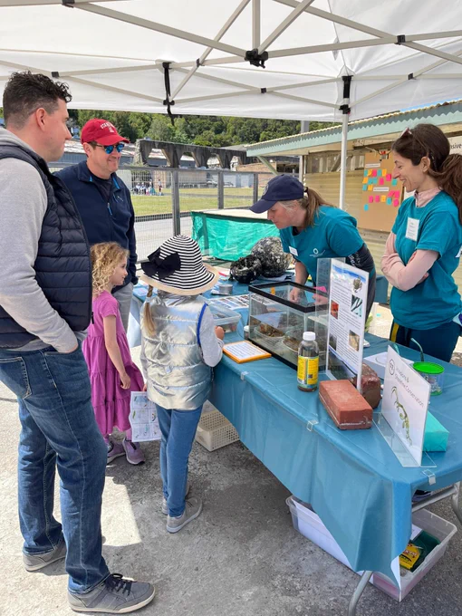 This photo shows Gail and Paula from SERC West at the EOS Center Marine Lab Open House SERC Booth. They are telling a few guests (two men and two young girls) about marine invertebrates in San Francisco Bay.  PC: Jessika De Jesus