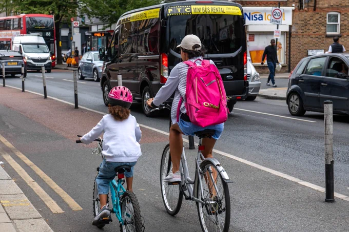 Parent and child cycling in a cycle lane