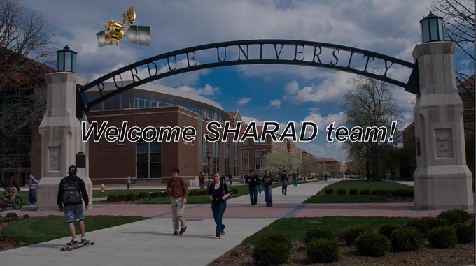 Picture of Purdue University archway on campus with text saying "Welcome SHARAD team" and the Mars Reconnaissance Orbiter photoshopped flying overhead