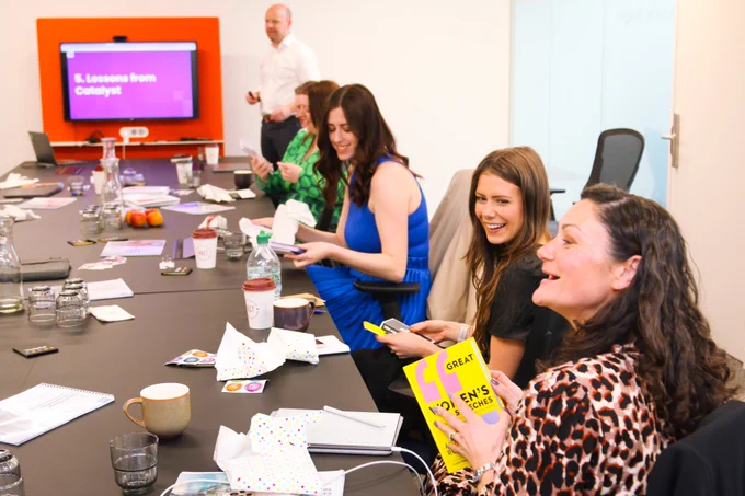 Some of the team receiving gifts and souvenirs at the conference table