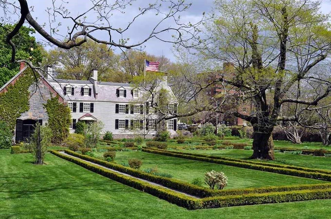 A colonial house with a large garden at Adams National Historical Park
