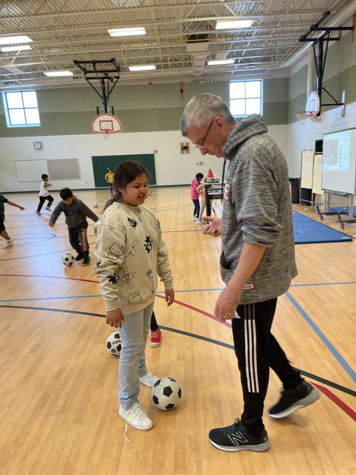 Mr. Carter and a 2nd grade student are discussing soccer ball exercises.
