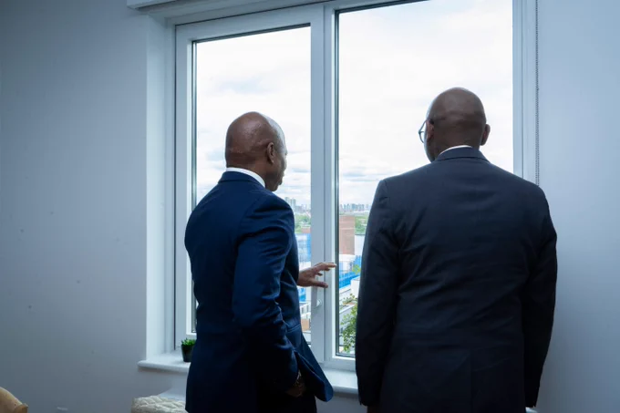 mayor and queens borough president look out window