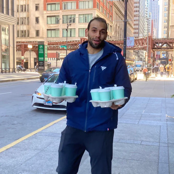Mohamed Elshorbagy holding 8 coffees