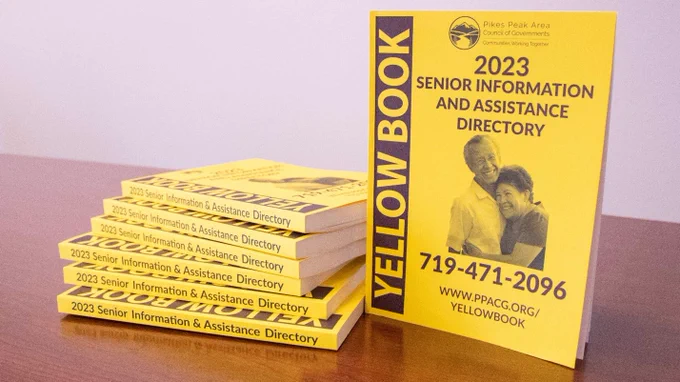 A stack of Yellow Books on top of a table.