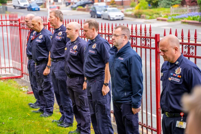 Firefighters observing a minute silence