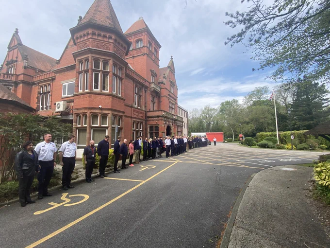 Firefighters and support staff stand to attention for minute's silence outside Service Headquarters