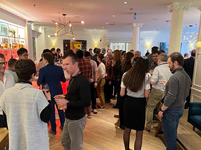 Guests of IQC's Quantum Connections conference mingling at a networking mixer event. 