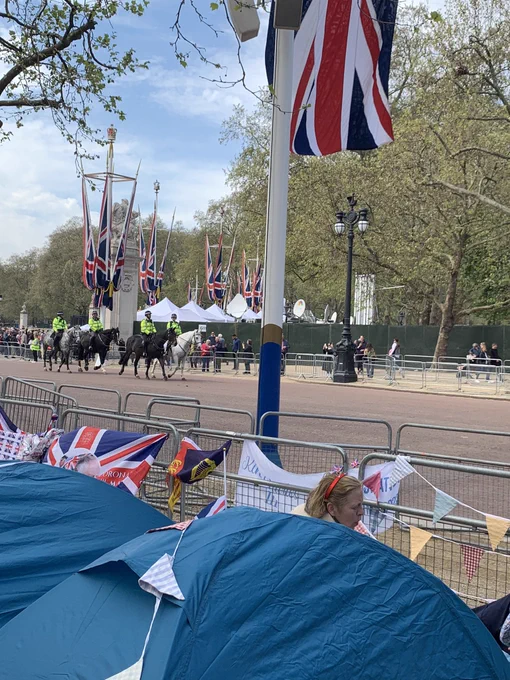 More tents & Union Jack flags. There are police horses riding down the mall in the distance.