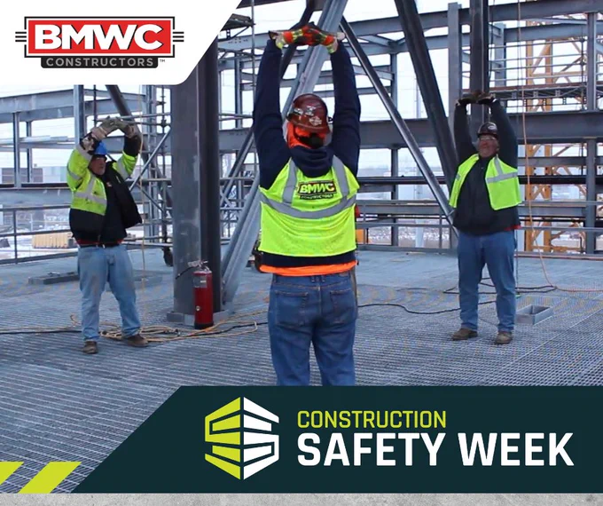 BMWC construction team stretch and flex on jobsite construction safety week 