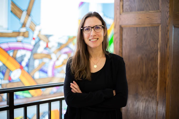A portrait of Maya Israel standing in the University of Florida College of Education building.