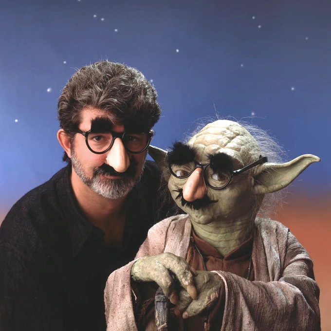 Portrait of George Lucas and Yoda, both wearing Groucho Marx noses, ©1990/2023 Tom Zimberoff.