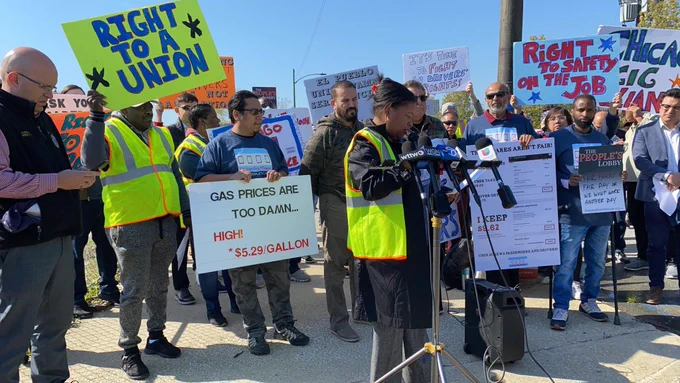 Drivers rally with signs that say: Right to a union, gas prices are too damn high! $5.29 per gallon, right to safety on the job