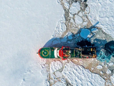 An aerial photo of the RRS Sir David Attenborough cutting through sea ice