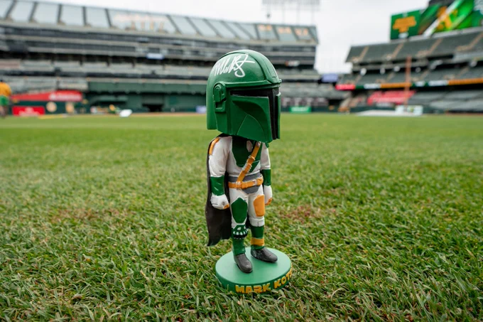Mark Kotsay Mandalorian Bobblehead on the field, autographed on the helmet.