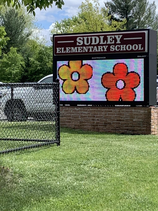 School sign with flowers.
