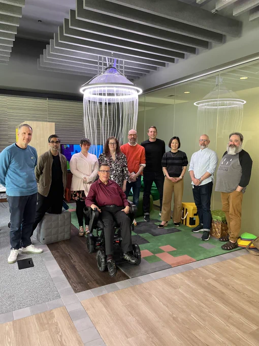 Image shows the team in a room behind the jellyfish.