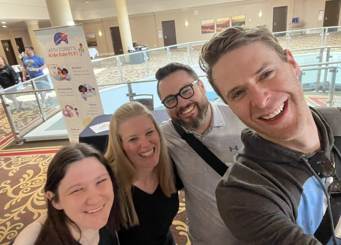 Photo of four smiling math colleagues who got to meet in real life!