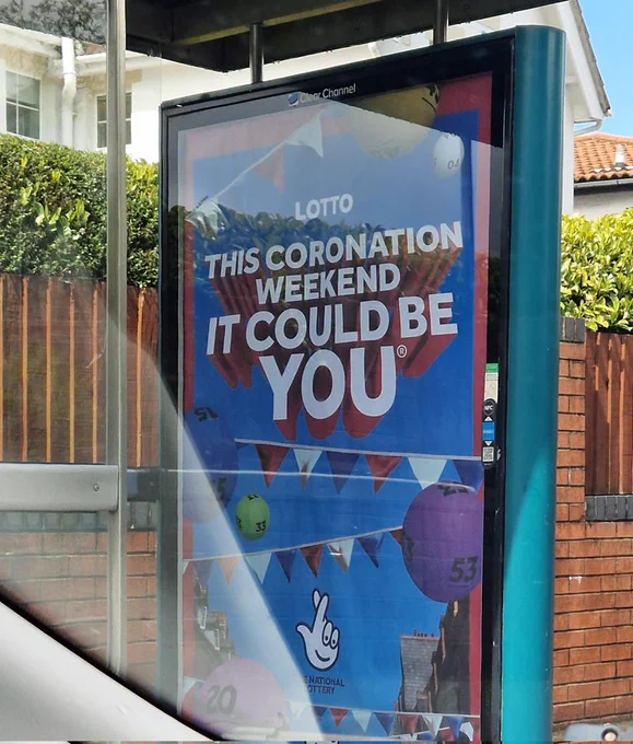 Bus stop poster advertising the National Lottery saying "This coronation weekend, it could be you"