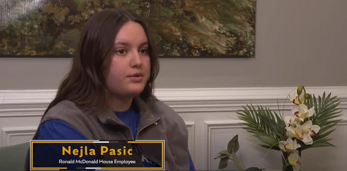 Nejla Pasic sits for an interview. The lower third reads: "Nejla Pasic, Ronald McDonald House Employee"