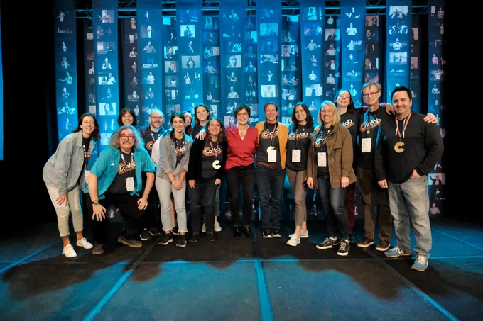 The Confab crew pose together on the stage.